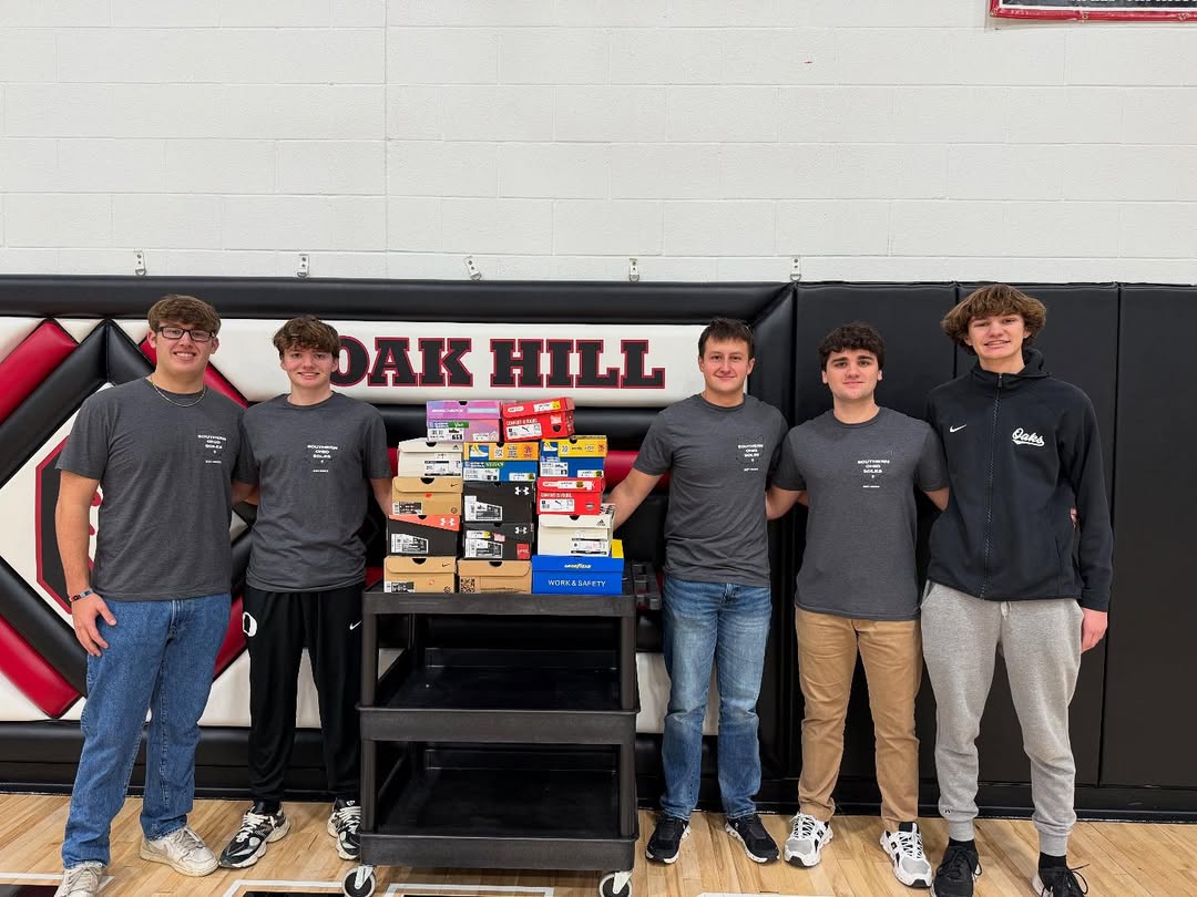 Southern Ohio Soles student representatives with a cart of new shoes at Oak Hill